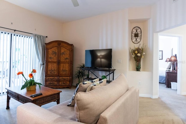 carpeted living room with ceiling fan