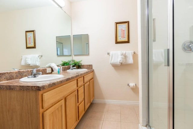 bathroom with vanity, a shower with shower door, and tile patterned floors