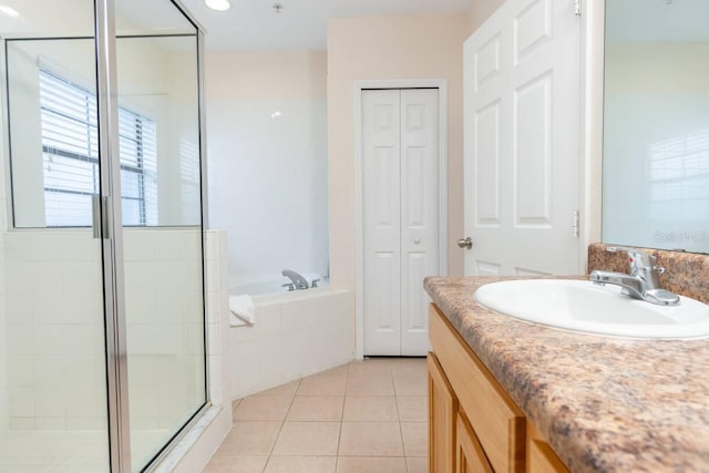 bathroom featuring tile patterned flooring, vanity, and separate shower and tub