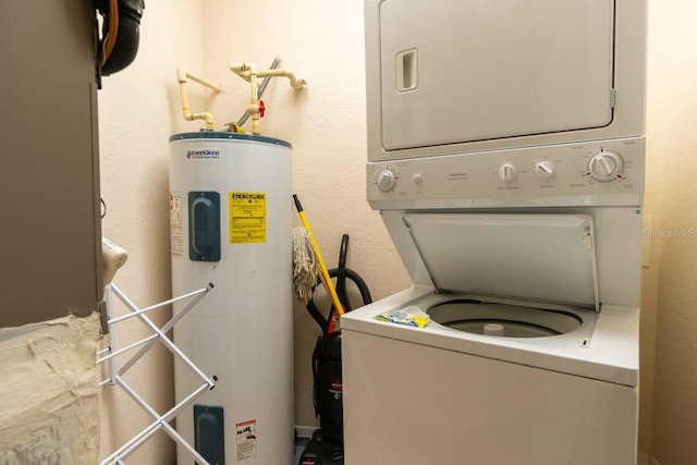 washroom with stacked washer / drying machine and electric water heater