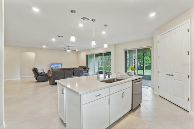 kitchen featuring a center island with sink, hanging light fixtures, sink, white cabinets, and dishwasher