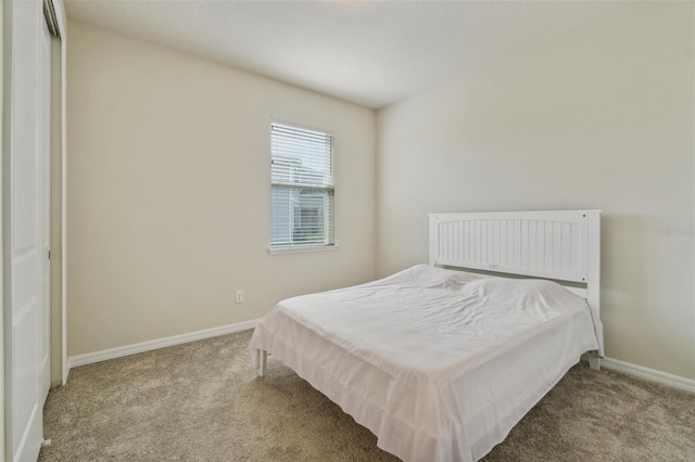 carpeted bedroom with a closet