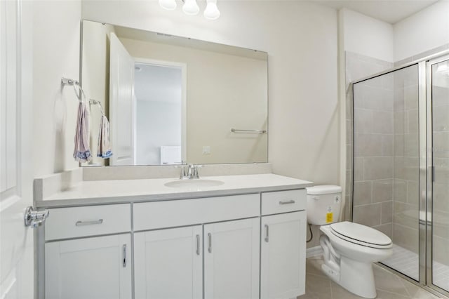 bathroom featuring tile patterned flooring, an enclosed shower, vanity, and toilet