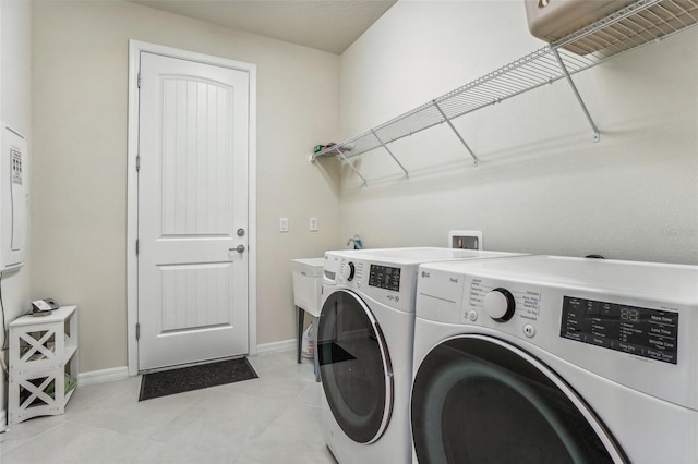 washroom with separate washer and dryer and light tile patterned floors