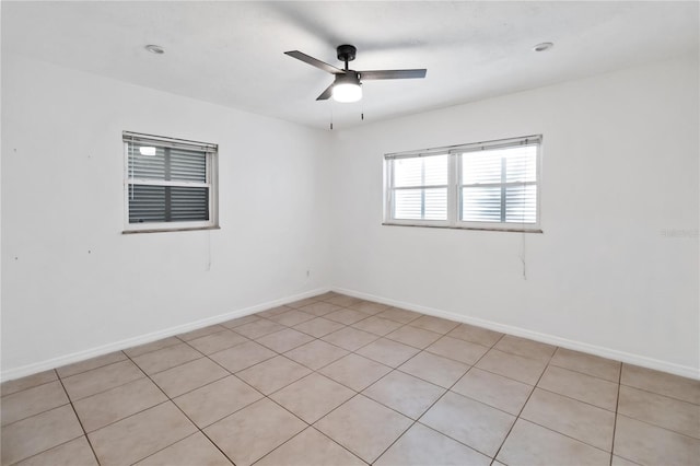 unfurnished room with ceiling fan and light tile patterned floors