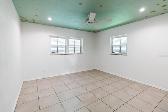 tiled empty room with ceiling fan