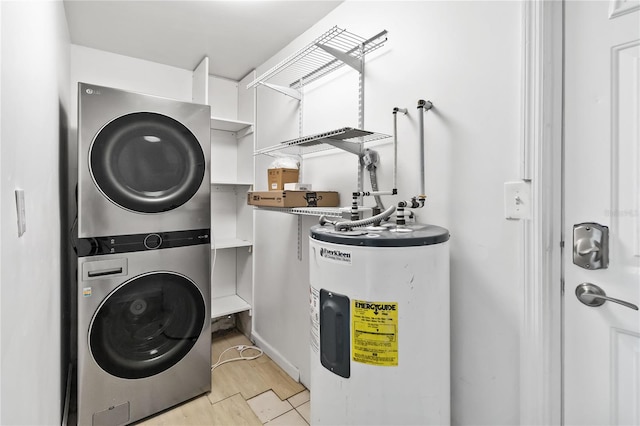 clothes washing area featuring stacked washer and dryer, water heater, and light hardwood / wood-style flooring