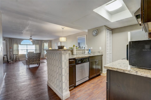 kitchen featuring dark hardwood / wood-style flooring, sink, stainless steel dishwasher, dark brown cabinets, and decorative light fixtures