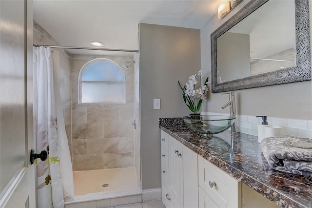 bathroom featuring vanity, tile patterned flooring, and curtained shower