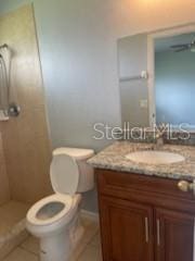 bathroom featuring tile patterned floors, vanity, and toilet