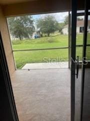 doorway to outside with concrete floors