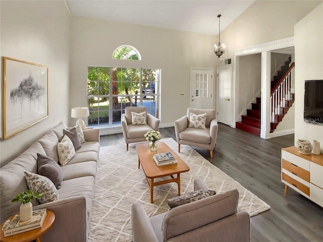 living room with a wealth of natural light, a chandelier, and hardwood / wood-style flooring