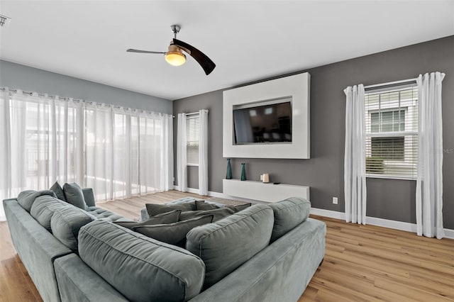 living room featuring ceiling fan and light wood-type flooring