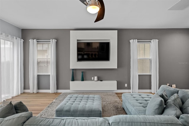 living room with ceiling fan and hardwood / wood-style floors