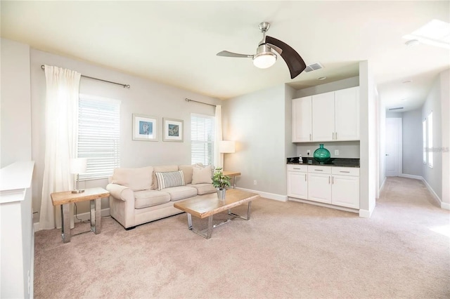 carpeted living room featuring ceiling fan