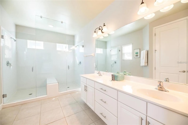 bathroom with tile patterned flooring, vanity, and a shower with shower door