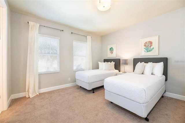 bedroom featuring light carpet