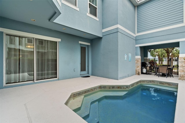 view of swimming pool with a patio