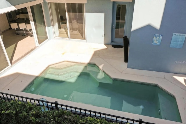 view of swimming pool with an in ground hot tub