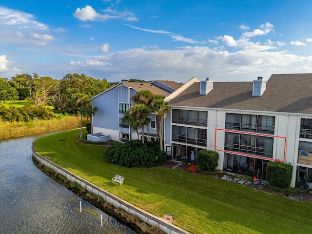 exterior space with a lawn and a water view