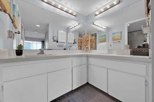 bathroom with vanity and a textured ceiling