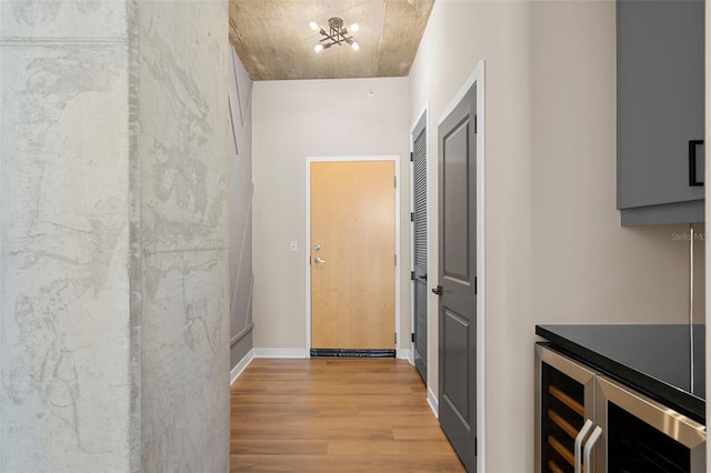 corridor featuring wine cooler and light hardwood / wood-style floors