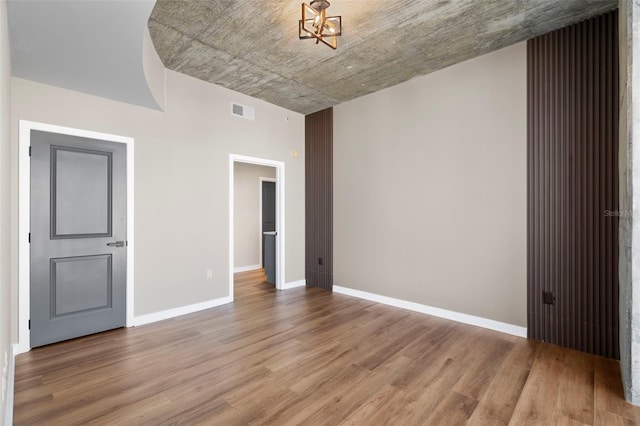 empty room with hardwood / wood-style floors