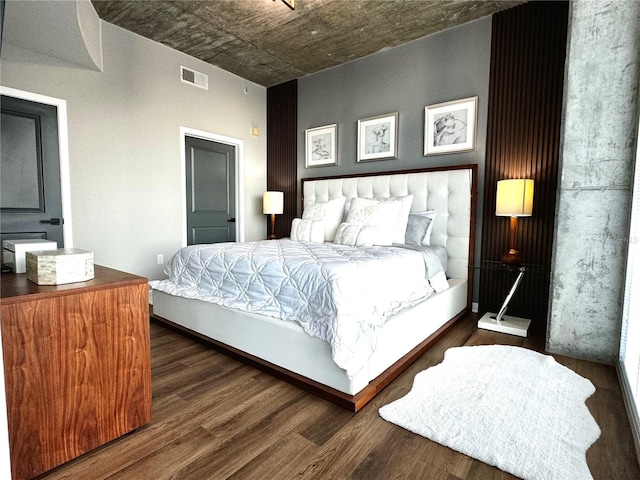 bedroom with dark hardwood / wood-style floors