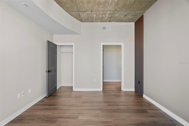 unfurnished bedroom with hardwood / wood-style flooring