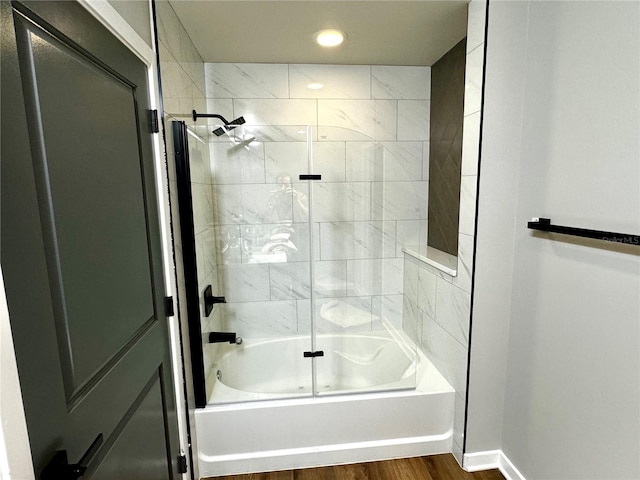 bathroom featuring hardwood / wood-style floors and shower / bath combination with glass door