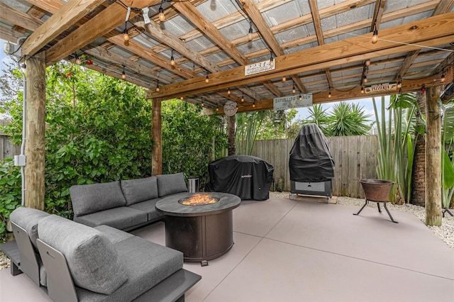 view of patio / terrace with grilling area and an outdoor living space with a fire pit