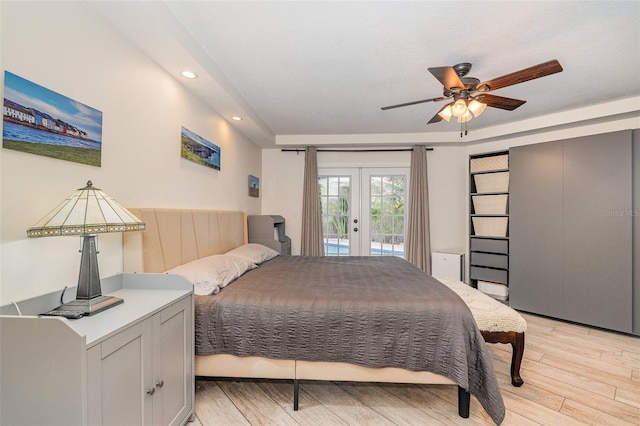 bedroom with access to exterior, french doors, light hardwood / wood-style floors, and ceiling fan