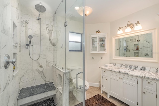 bathroom featuring hardwood / wood-style floors, vanity, toilet, and walk in shower