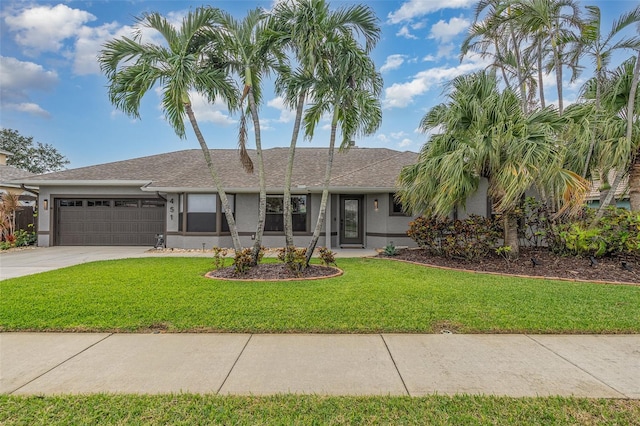 view of front of property with a front lawn and a garage