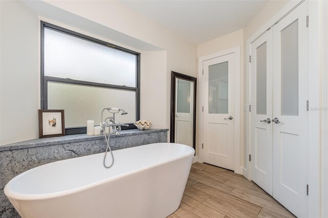 bathroom featuring hardwood / wood-style floors and a bathtub