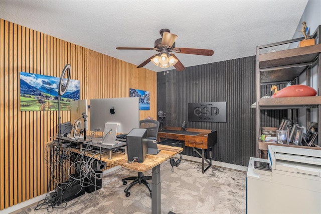 office space with ceiling fan, light colored carpet, and a textured ceiling