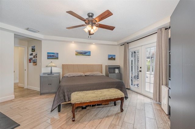 bedroom with access to outside, french doors, ceiling fan, light wood-type flooring, and a textured ceiling