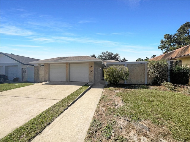 single story home featuring a front lawn and a garage