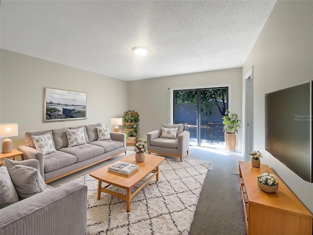 carpeted living room featuring a textured ceiling