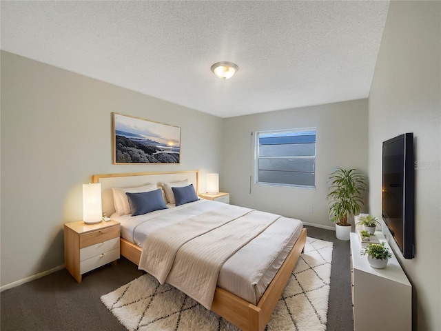 carpeted bedroom with a textured ceiling