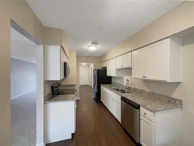 kitchen with light stone counters, stainless steel appliances, white cabinetry, dark hardwood / wood-style floors, and sink