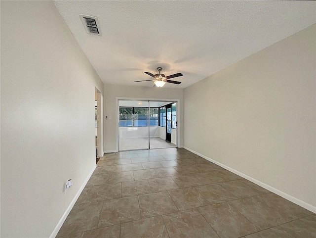 spare room with a textured ceiling and ceiling fan