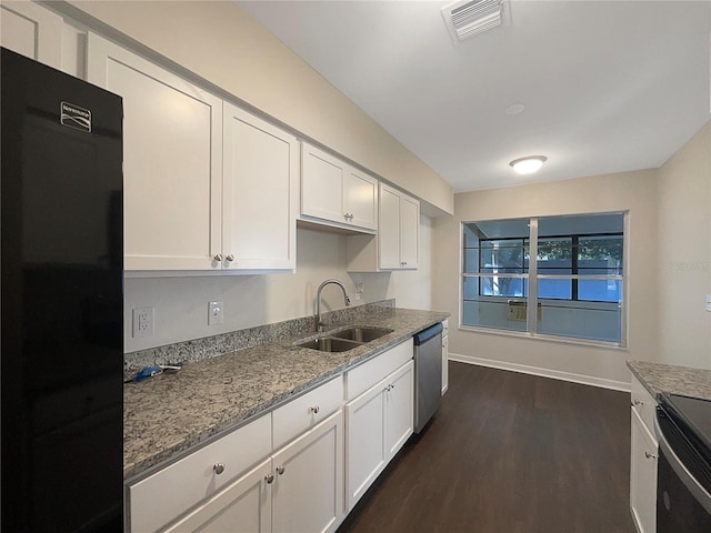 kitchen featuring dark hardwood / wood-style flooring, black refrigerator, dishwasher, white cabinets, and sink