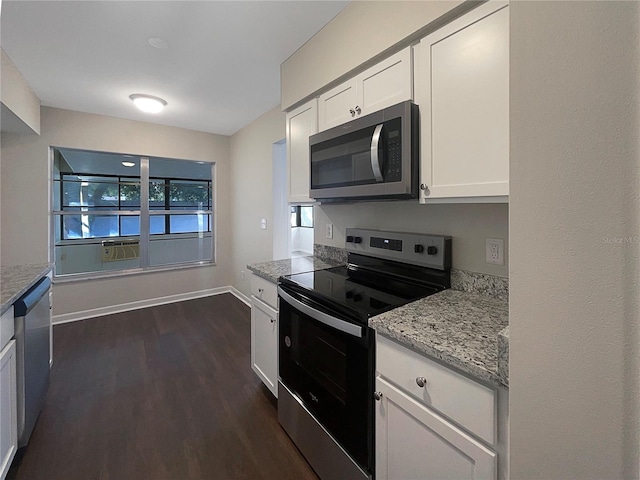 kitchen with dark hardwood / wood-style flooring, white cabinetry, light stone counters, and appliances with stainless steel finishes