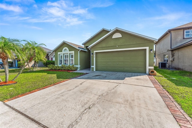 ranch-style home featuring cooling unit, a front yard, and a garage