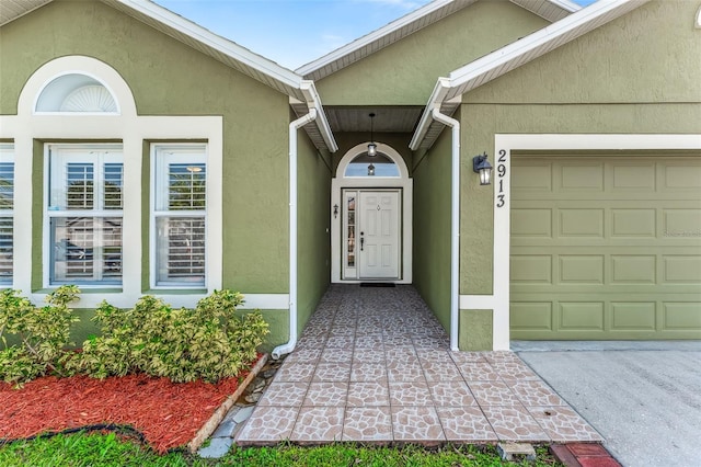 view of exterior entry featuring a garage