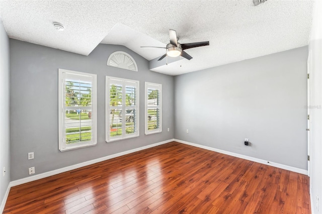 spare room featuring a textured ceiling, ceiling fan, dark hardwood / wood-style flooring, and lofted ceiling