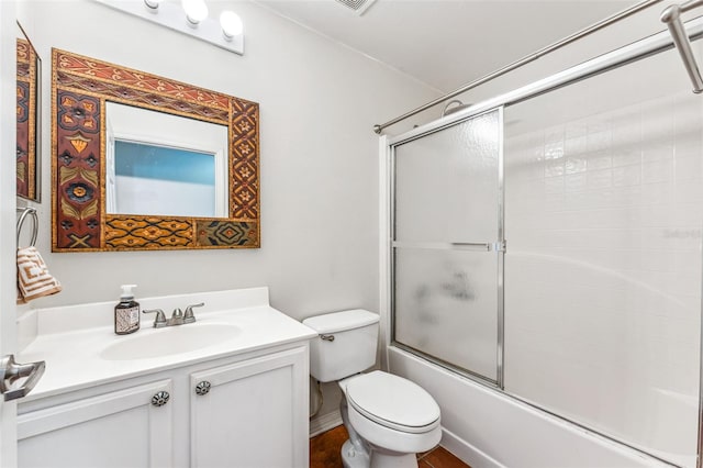 full bathroom featuring vanity, toilet, and bath / shower combo with glass door