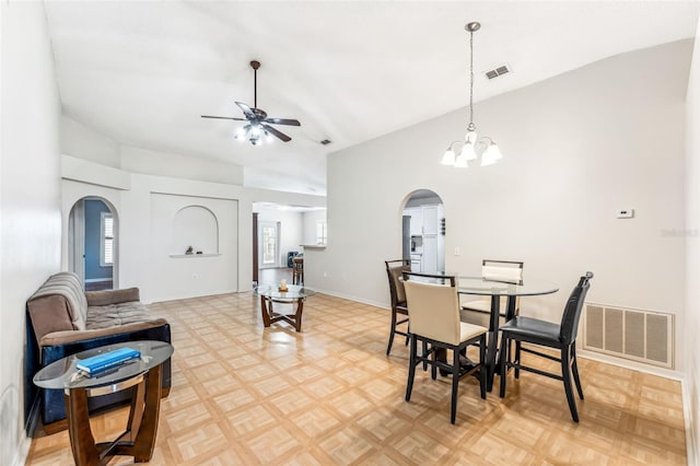 dining room with a wealth of natural light, parquet floors, and lofted ceiling