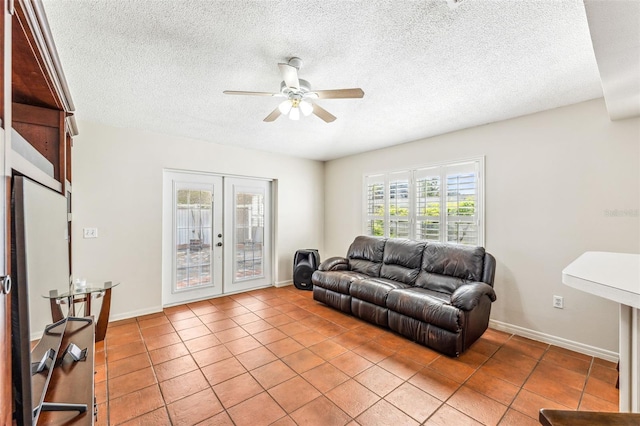 living room with french doors, a textured ceiling, light tile patterned floors, and ceiling fan